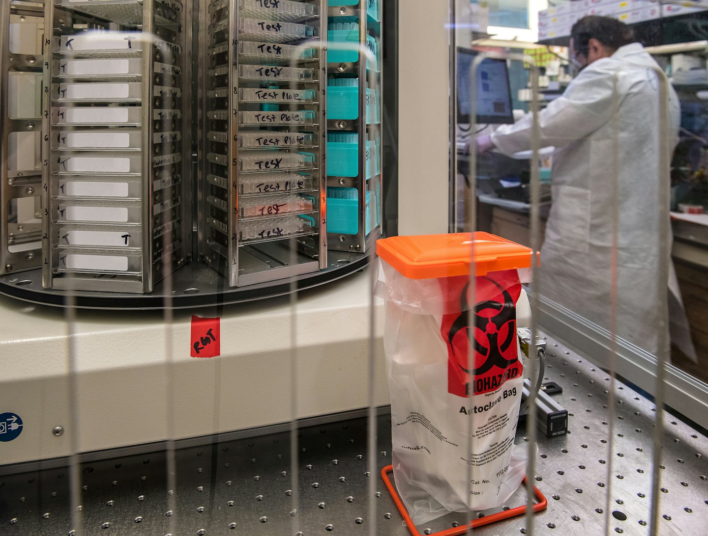 Rotating rack of labeled sample trays in a laboratory.